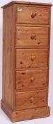A collection of pine furniture to include a pine bookcase, a tall pine upright,