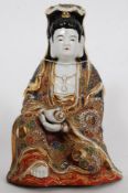 A mid 20th century Japanese Satsuma glazed figurine of Buddha with hand finished paint work.