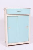 A vintage 1950's two tone kitchen dresser cabinet having blue formica top over drawer and cupboard.