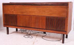 A vintage 1970's retro teak stereogram by Ferguson having a metamorphic sliding front with inset