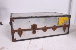 A vintage aluminium 20th century steamer trunk having hinged centre with clasps and metal banding
