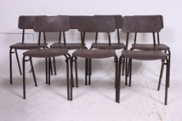 A retro 1970's stack of childrens plastic stacking chairs having moulded plastic seats with tubular