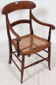 An Edwardian mahogany bergere / caned armchair.