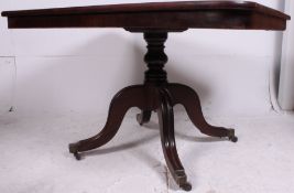 A 19th century large mahogany tilt top dining table having reeded shaped legs with tilt top column