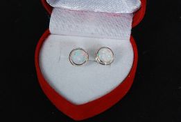 A pair of white metal ( stamped 925 indicating silver ) and opalite stud earrings