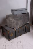 A canvas and wooden bound steamer trunk having hinged clasp together with a metal tin trunk and