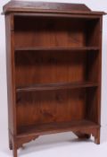 A 1930's Arts & Crafts revival oak open window bookcase cabinet having gallery top with fixed