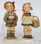 A pair of Hummel figurines - Girl with basket together with a boy with hands in pockets,
