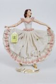 A Dresden lace work figurine of a ballerina having blue marked Crown with N underneath to the base.