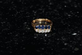 18ct Sapphire and Diamond 18ct gold ring set with twin 5 stone channels and scroll shank.