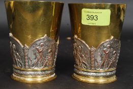 A pair of Elkington & Co gilded metal and electrotype beakers of cylindrical tapering form having