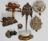 A collection of early 20th century military cap badges to include The Kings Own, Border Regt,