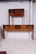 A large 1970's retro teakwood fitted double headboard unit by Uniflex.