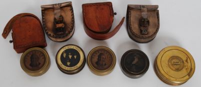 A  collection of compasses set within brass cases to include examples by Stanley,