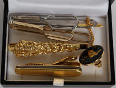 A collection of Gentleman's tie pins to include a pen knife,