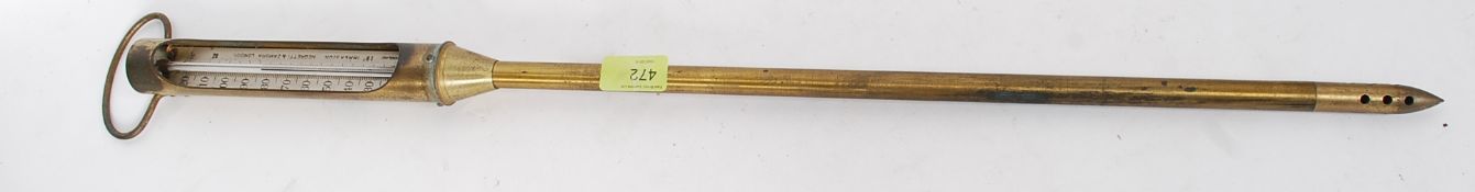 An early 20th century brass Negretti & Zambra ground thermometer / barometer marked to the stem.