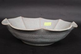 A large Chinese celadon green crackle glaze fruit bowl in the form of a flower head with impressed