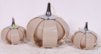A set of unusual plastic 1970's pendant lamps in a dark beige colour having retro styling's typical