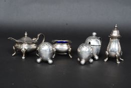 A collection of silver plate condiments to include EPNS condiments and blue glass table salt