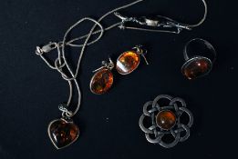 A collection of white metal and silver amber jewellery (set) to include; ring, 2x brooches,