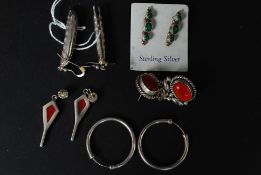 A selection of four pairs of gem set silver earings to include a pair of contemporary stylised Pea