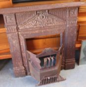 An early 20th century original cast iron fireplace complete with grate