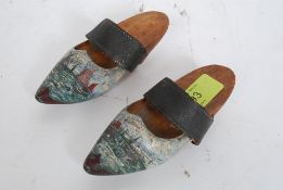 A handpainted pair of 19th century miniature wooden shoes with decorative continental scene marked