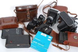 A collection of vintage cameras and binoculars to include Ensign, Zenit,