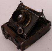 An antique folding bellows plate camera with brass fittings - AF.