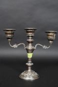 A hallmarked silver three branch candelabra by B&Co, with hallmarks to the base. Marked as 'filled'.