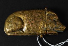An antique style brass vesta case in the form of a pig.