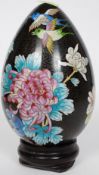An 20th century Chinese cloisonne egg of foliate and bird design,
