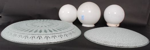 A collection of five retro glass light shades / fittings, two being decorative designs,