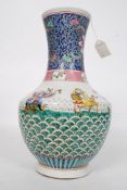 A large famille verte bottle vase depicting Immortals on Lotus leaves ,