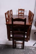 An excellent large solid oak refectory dining table having extending draw leaves with a set of 8