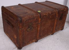 A late 19th century canvas and wooden strap steamer trunk,