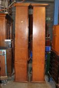 A pair of unusual large walnut pilaster cabinets having flared tops with upright bodies of shelves