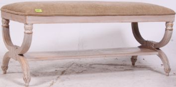 A 20th century French upholstered Louis style window seat having overstuffed frame crossed frame