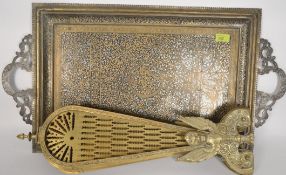A Victorian style peacock opening fire screen, along with an Arabian style brass tea tray.