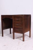 A 1940's oak clerks desk having a series of drawers flanking an open kneehole recess.