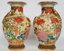 A pair of 20th century foreign made oriental vases, with relief decoration of dragons to rim.