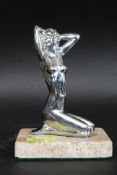 A 20th century nude lady chrome ( possibly a car mascot ) affixed to a later marble base for