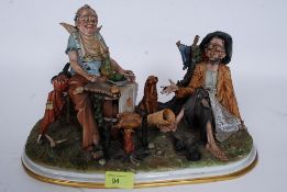 A Capodimonte porcelain figure group `Dolce Vita`, 20th Century, modelled as two tramps,