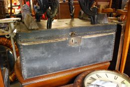 An early 20th century carved and wooden bound steamer trunk having hinged centre with clasps to the