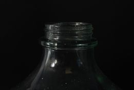 A large 20th century olive oil glass bottle having bulbous body with waisted neck