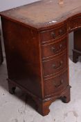 A Georgian style mahogany bow front twin pedestal desk by Bevan Funnel - Reprodux.