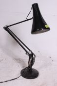 A vintage mid 20th century Herbert Terry anglepoise desk lamp with circular base and pendant shade.