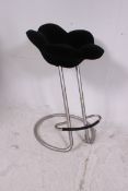 A 20th century retro bar stool having tubular metal cantilever style frame with upholstered flower