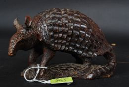 A carved South American hardwood tribal figurine on an Armadillo