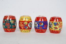 A collection of four brightly coloured Chinese storage jars all with marks to base